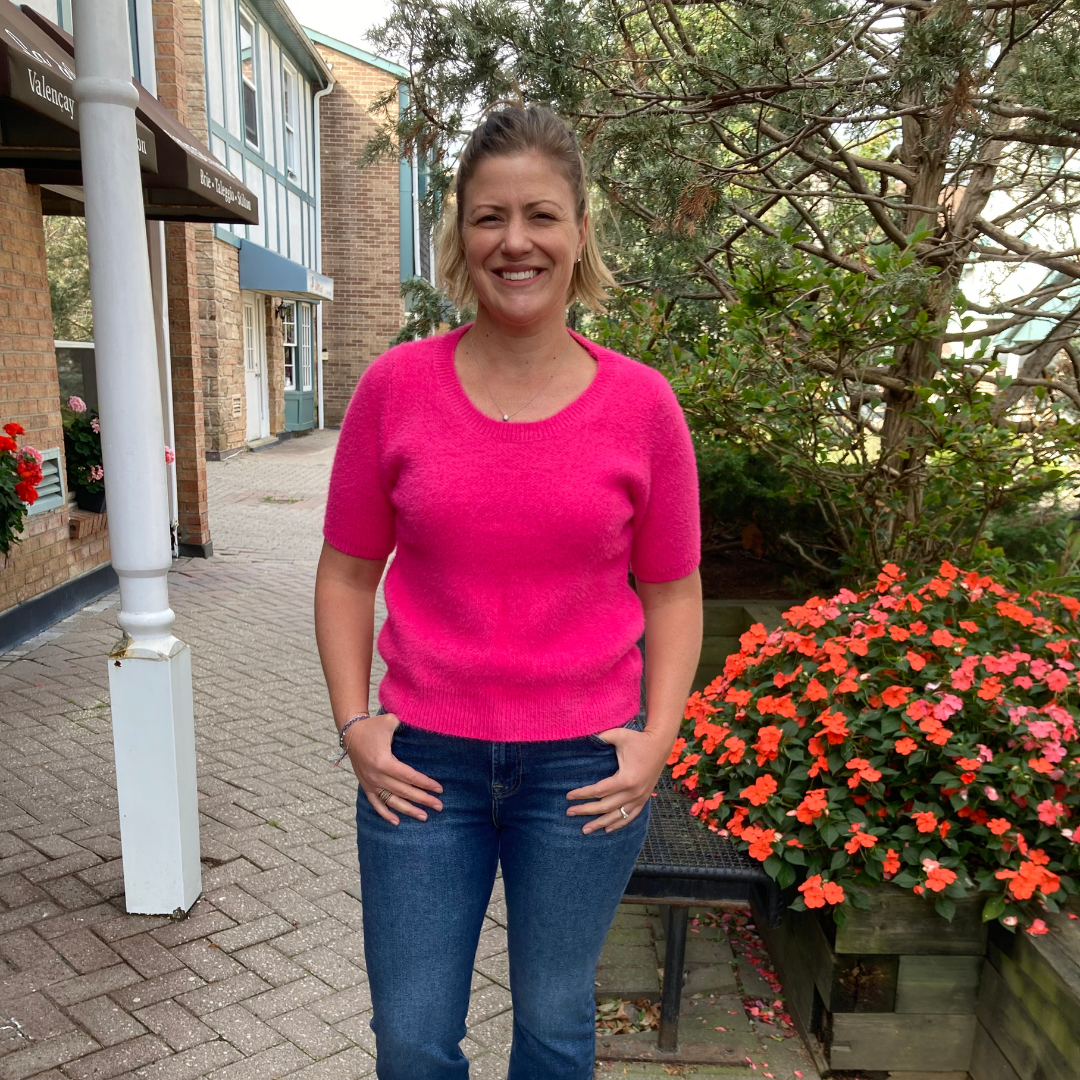 Tracy standing outside Lemonberry in Aurora, wearing a pair of 7 For All Mankind premium demin.