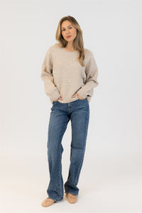 Model wearing Lyla & Luxe BOWS-F25 eco crewneck sweater with pearl bows in beige, standing studio view – Lemonberry
