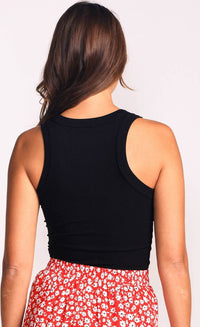 Back view of woman wearing black Danika top with red floral skirt
