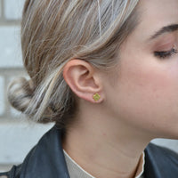 Side view of Foxy Originals Maple Leaf stud earrings in gold, worn outdoors — photographed near Lemonberry in Aurora, ON
