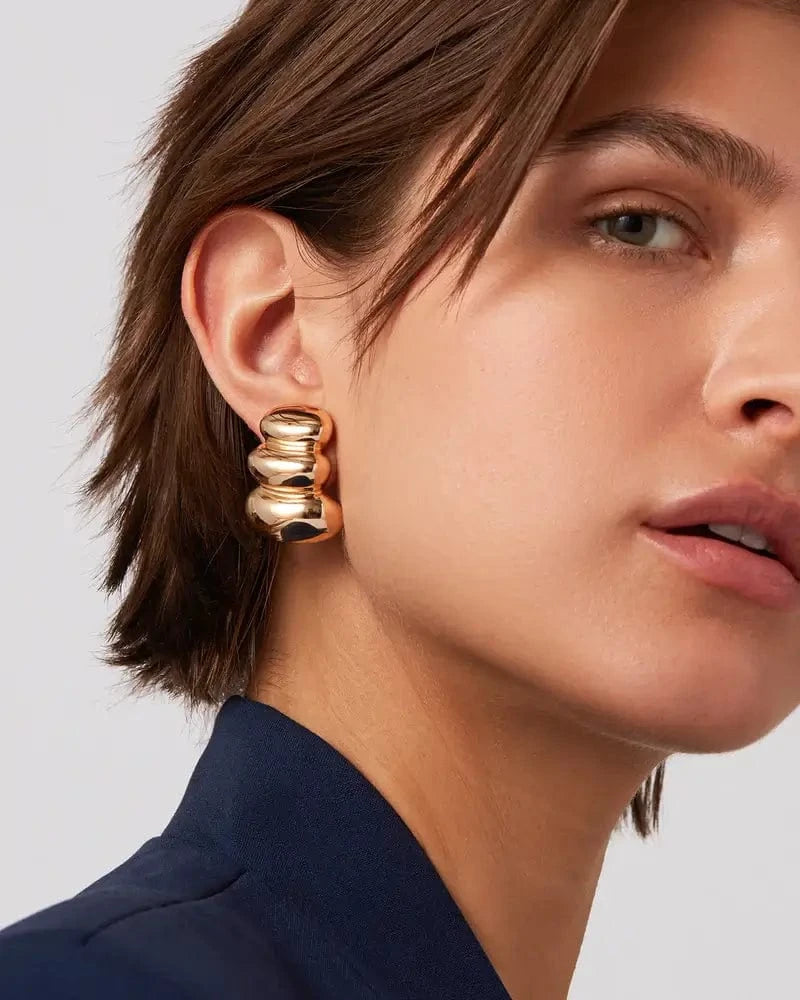 Non-Stop Earrings by Jenny Bird styled with navy blazer — statement gold jewelry worn in Aurora, ON