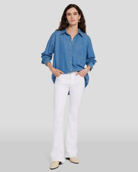 Model wearing white Tailorless Bootcut by 7FAM with denim top.