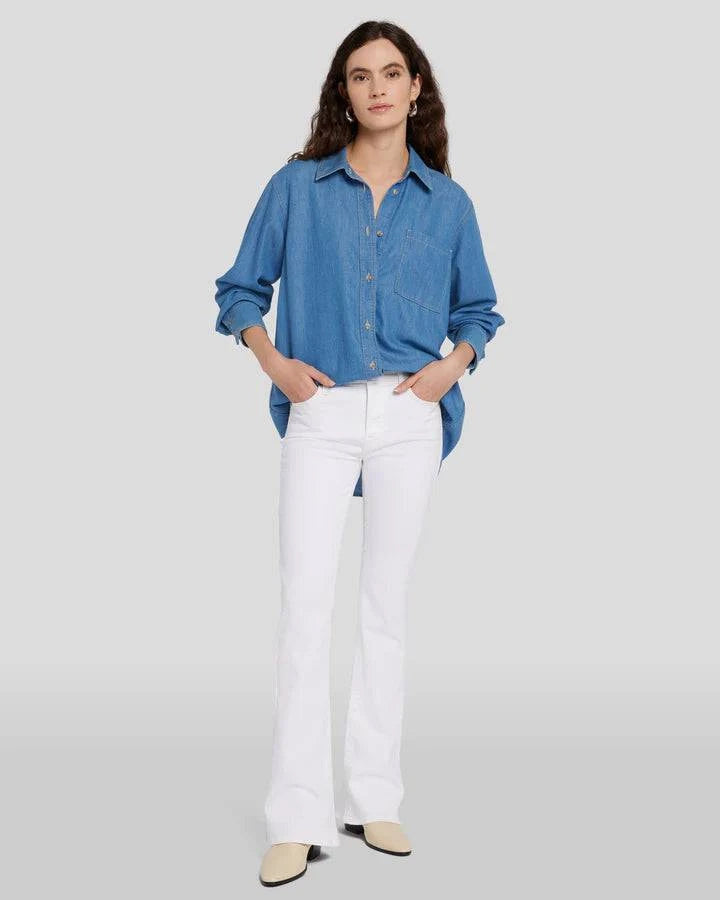Model wearing white Tailorless Bootcut by 7FAM with denim top.
