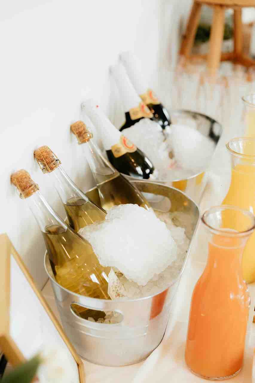 Bottles of champagne chilled in a silver ice bucket, ready for brunch mimosas.