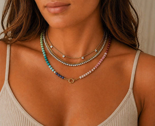 Colourful gemstone necklaces layered with chains and pendants at Lemonberry