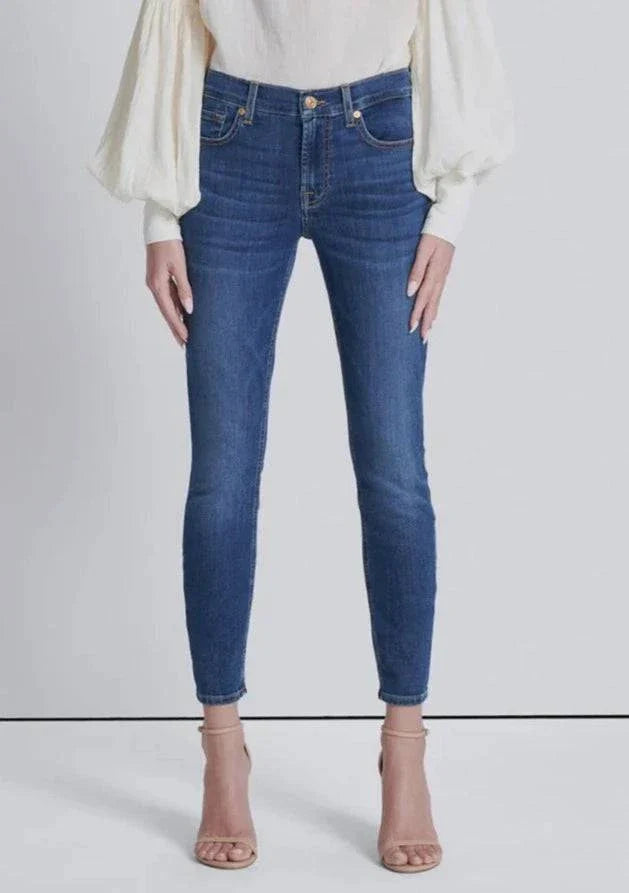 Full front view of high-waisted skinny jeans in a medium wash, fitted through the legs with an ankle-length cut
