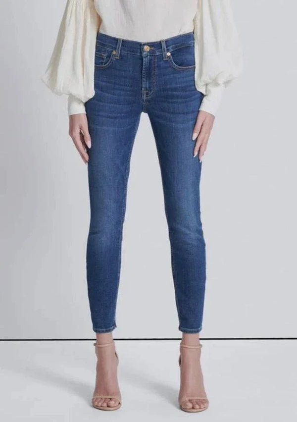 Full front view of high-waisted skinny jeans in a medium wash, fitted through the legs with an ankle-length cut