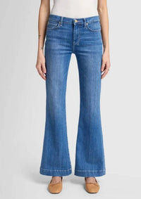 Close-up of the 7 For All Mankind Dojo Tailorless jeans in medium blue, showcasing the front waist and relaxed fit with the signature 7 back pocket.