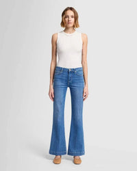 Full front view of the 7 For All Mankind Dojo Tailorless jeans in medium blue, showing the fitted hips, relaxed leg, and wide trouser cuff for a stylish, comfortable look.