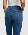 Back view of the 7 For All Mankind High Rise Ankle Skinny jeans, showcasing the contoured fit and gentle fading with whiskering in a classic blue wash.
