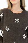 Dark brown Aiden Daisy sweater with white embroidered flowers, crew neck, styled with jeans – available at Lemonberry Aurora

