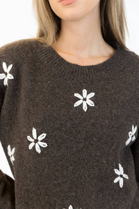 Dark brown Aiden Daisy sweater with white embroidered flowers, crew neck, styled with jeans – available at Lemonberry Aurora

