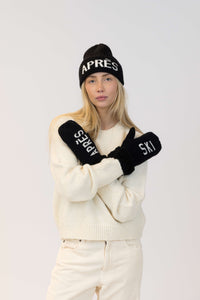 Person wearing a white outfit with black 'APRES SKI' text on a plain background