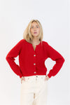 Woman wearing a red cardigan on a white background