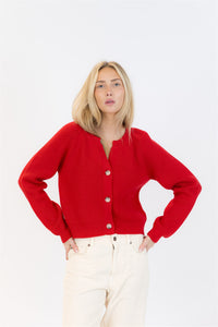 Woman wearing a red cardigan on a white background