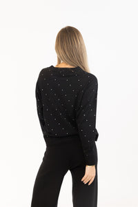 Woman wearing a black outfit with star patterns on a white background
