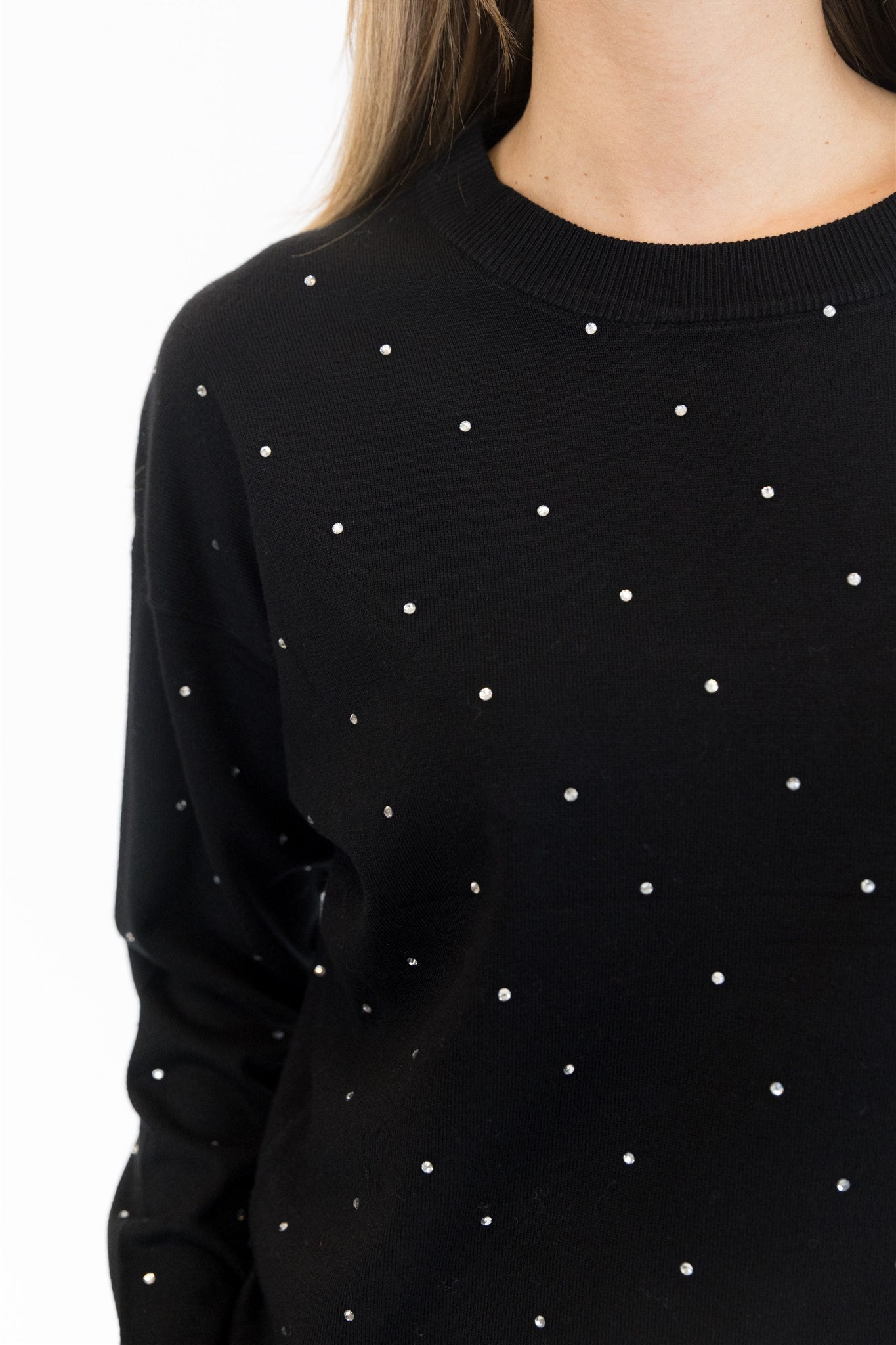 Black sweater with white polka dots on a white background