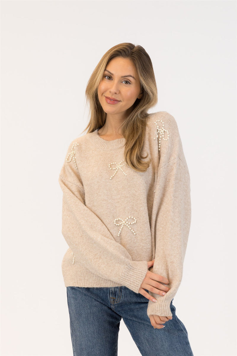 Close-up of neckline and pearl bow detailing