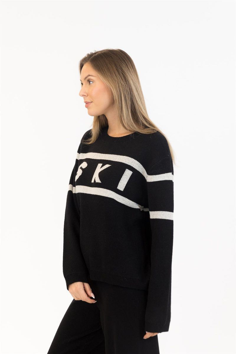 Side view with black wide-leg knit pants and BRIXTON pullover – cozy cold-weather set