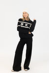 Styled with white beanie for winter-ready look, photographed in studio