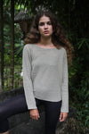Front view of the Beach Comber relaxed boatneck sweater in linen with black leggings – A relaxed fit boatneck sweater made from linen and organic cotton, paired with black leggings. Available at Lemonberry, Aurora, ON.