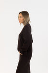 Side profile of model wearing chocolate brown sweater set