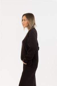 Side profile of model wearing chocolate brown sweater set