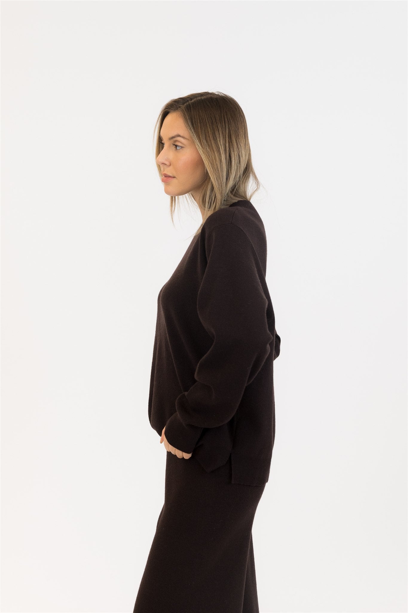 Side profile of model wearing chocolate brown sweater set