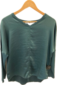 Green blouse on a wooden hanger against a white background inside Lemonberry