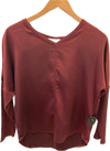 Melissa Nepton's Cindy long sleeve top on a wooden hanger against a plain background