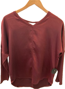 Melissa Nepton's Cindy long sleeve top on a wooden hanger against a plain background