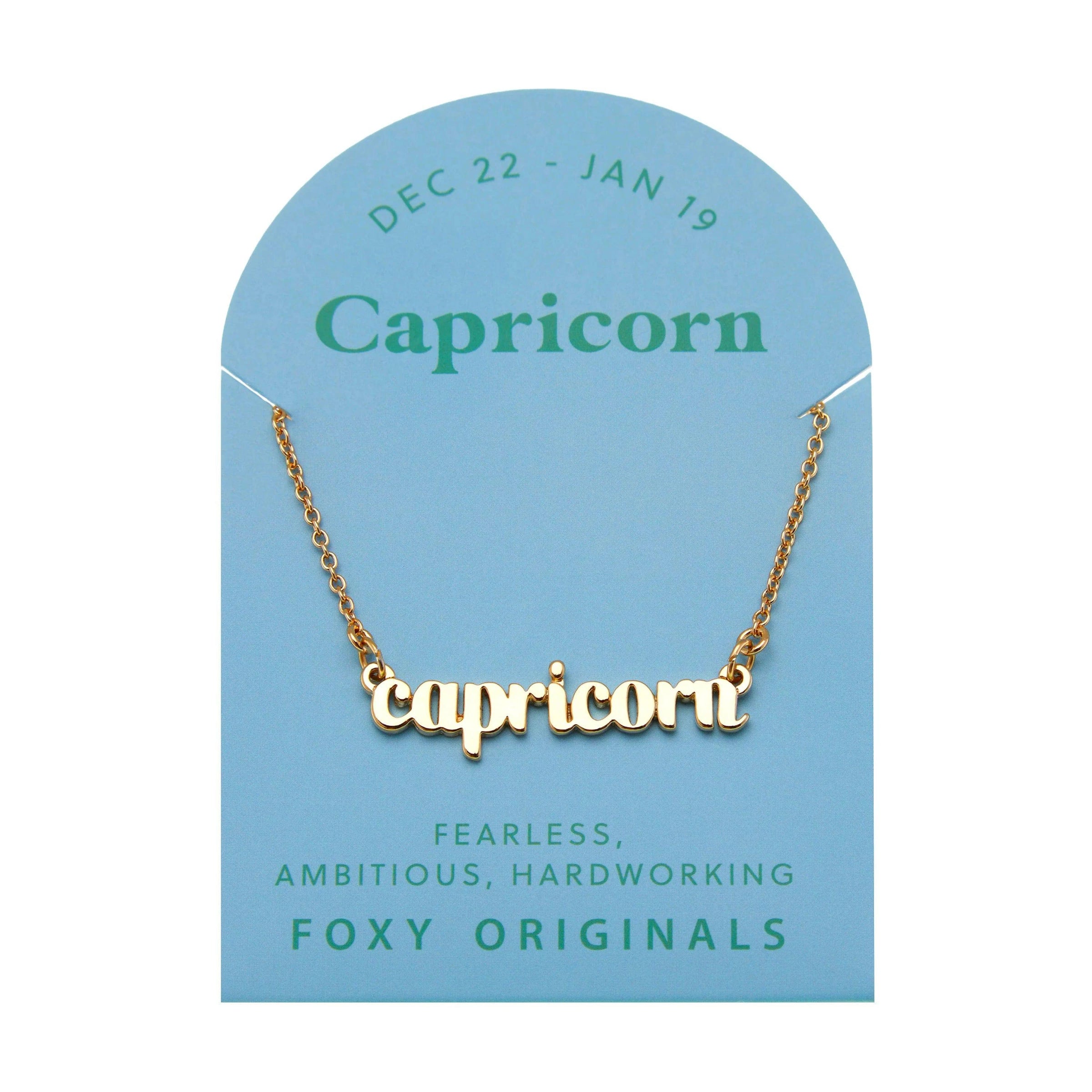 Foxy Originals Capricorn Zodiac Necklace on its display card, featuring a gold script-style pendant with stylish packaging.
