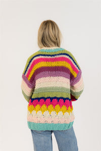Back view of rainbow knit cardigan with thick rows of bright colour