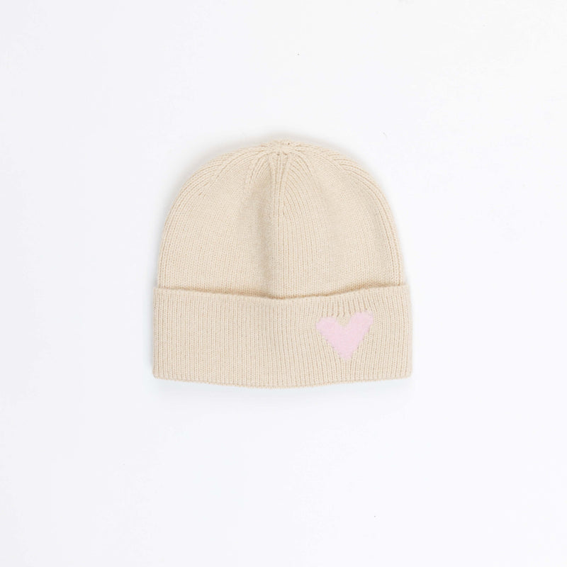 Beige knit beanie with a pink heart on a white background