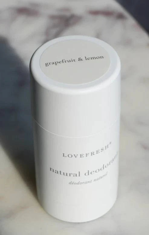 A close-up of Lovefresh Grapefruit & Lemon Natural Deodorant in regular strength, showcasing its smooth texture and bright, citrus-themed packaging.