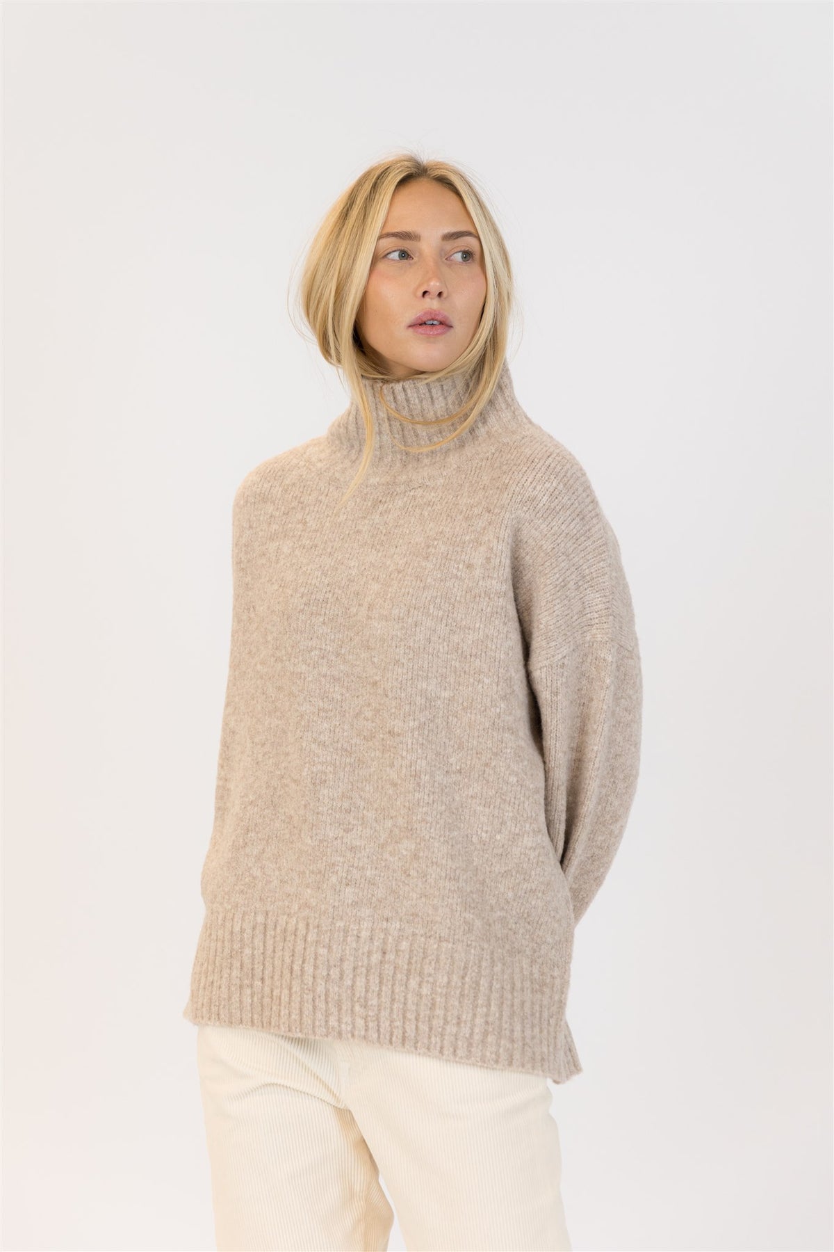Close-up of oat mockneck sweater, ribbed collar detail and soft texture