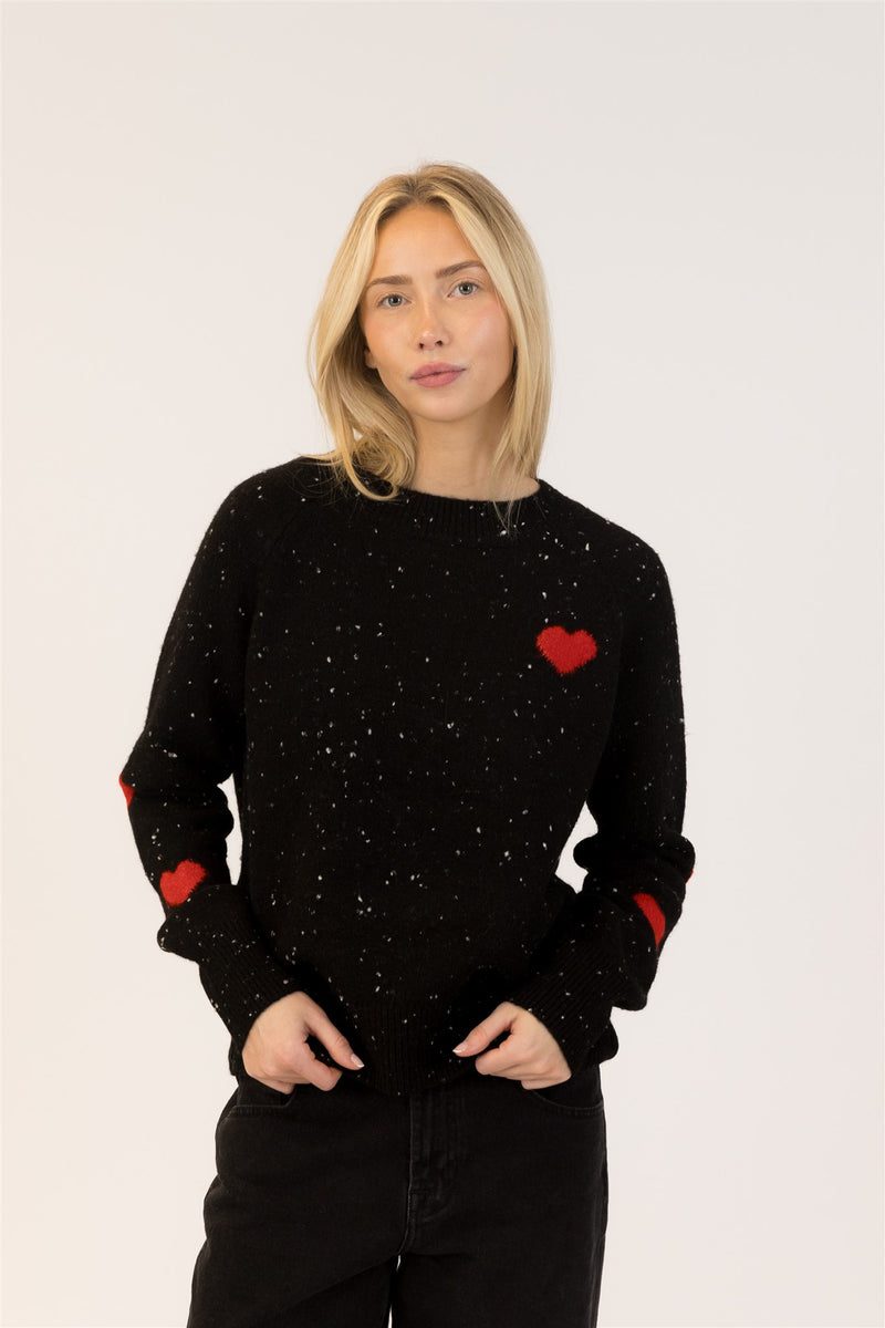 Lyla & Luxe Philippa pullover in black fleck with red heart detail, styled with black denim