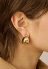 Paige Puff Earrings on a model with brown hair.