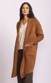 Side angle of Stockport Jacket by Pink Martini showing pocket detail and length, worn with jeans, Toronto setting.