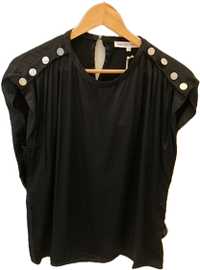 Black top with white buttons on a wooden hanger