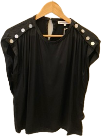 Black top with white buttons on a wooden hanger