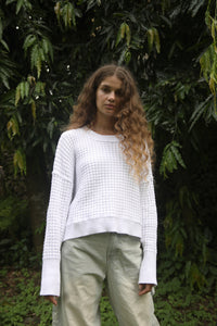 Front angle of a white waffle-knit sweater with baggy pants, showing its cozy, lived-in style. Available at Lemonberry, Aurora, ON.
