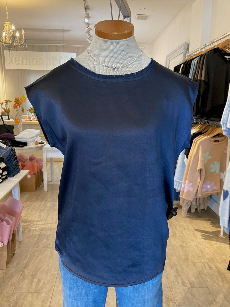 Blue sleeveless Willow top by Melissa Nepton on a mannequin inside Lemonberry