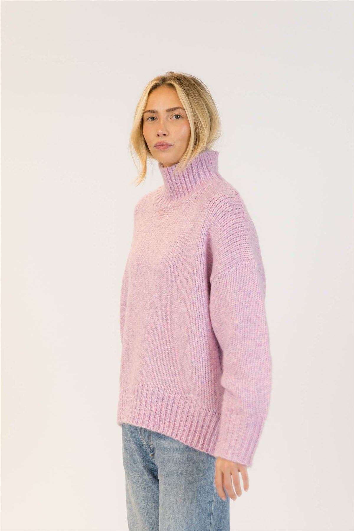 Woman styling Lyla & Luxe Aggie pink mix sweater in a cozy, relaxed look