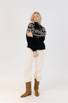 Full outfit featuring Lyla & Luxe Fair Isle sweater in black and white paired with cream cord pants.