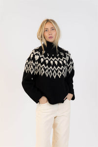 Lyla & Luxe Aggie turtleneck sweater styled with cream pants and hands in pockets for a relaxed winter look.