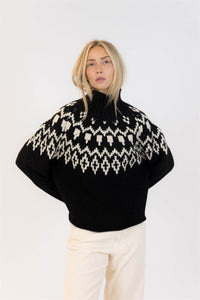 Close-up angle of Lyla & Luxe black Fair Isle knit sweater, winter-ready with chunky texture.