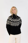 Front view of Lyla & Luxe Aggie sweater in black with white Fair Isle pattern, cozy oversized fit.