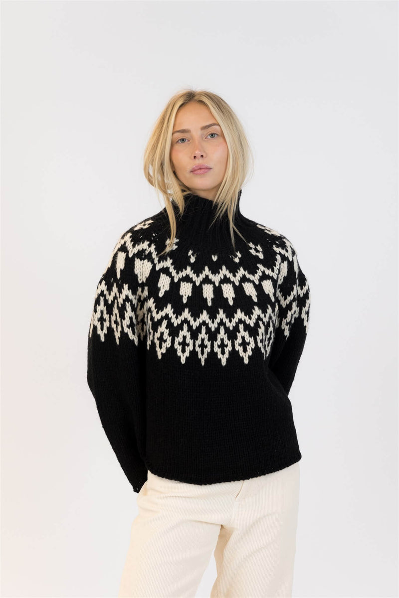 Front view of Lyla & Luxe Aggie sweater in black with white Fair Isle pattern, cozy oversized fit.