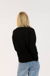 Back view of Lyla & Luxe Ajax Sherpa Sweater in black knit with plain back and ribbed hem